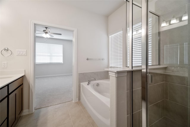 bathroom featuring ceiling fan, a garden tub, vanity, a shower stall, and tile patterned floors