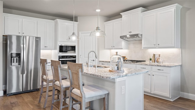 kitchen with white cabinetry, sink, hanging light fixtures, a kitchen island with sink, and stainless steel appliances