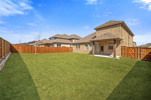 view of yard featuring a patio area and a fenced backyard