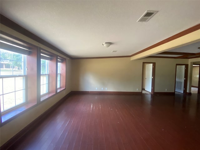 unfurnished room with ornamental molding, a textured ceiling, and dark hardwood / wood-style floors