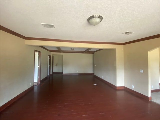 unfurnished room with ornamental molding, a textured ceiling, and dark hardwood / wood-style floors