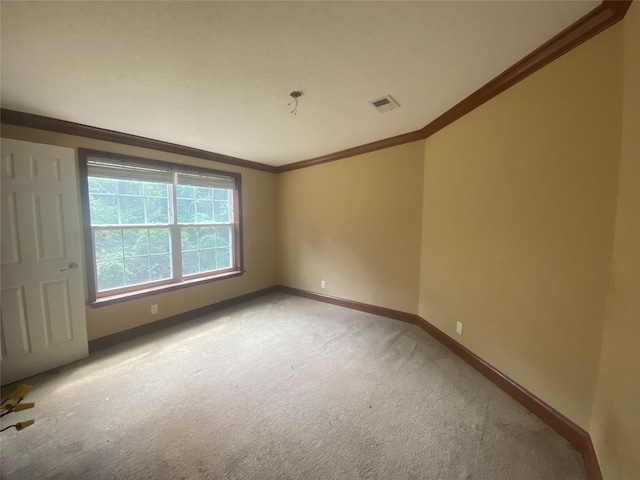 carpeted empty room featuring ornamental molding