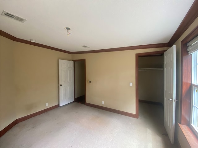 carpeted spare room featuring crown molding