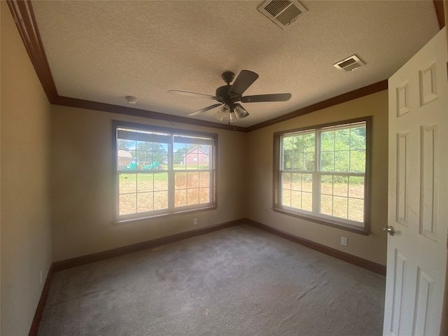 carpeted empty room with ornamental molding, ceiling fan, and a textured ceiling