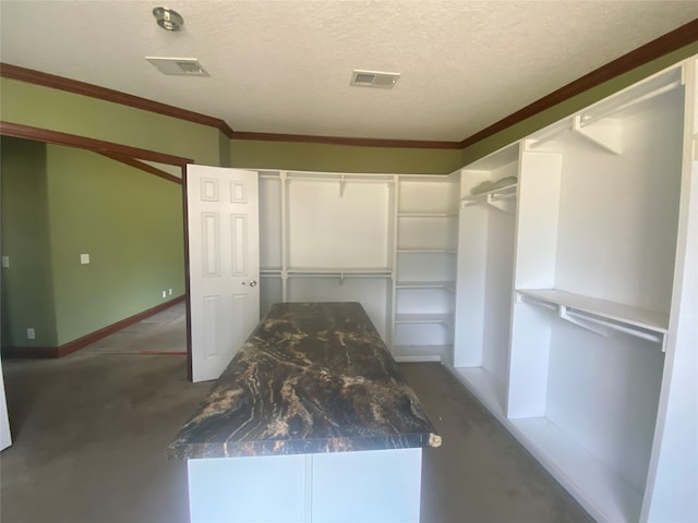 interior space with a textured ceiling, a closet, and ornamental molding