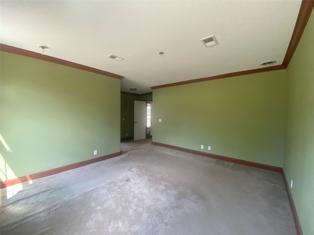 carpeted spare room with crown molding