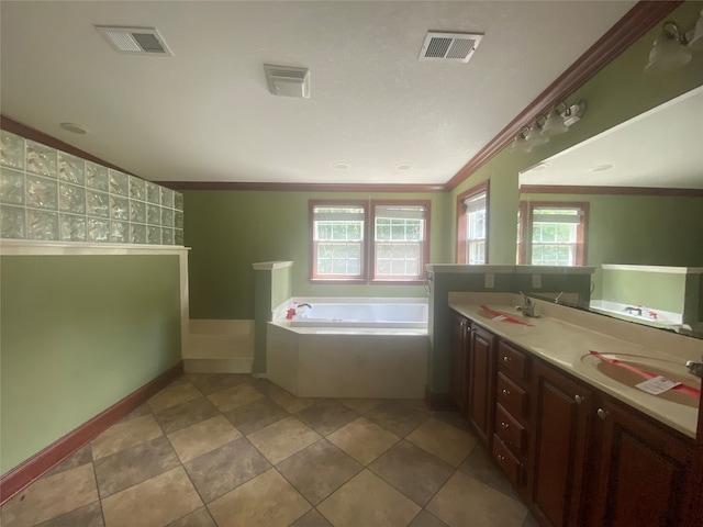 bathroom featuring ornamental molding, a wealth of natural light, tiled tub, and vanity