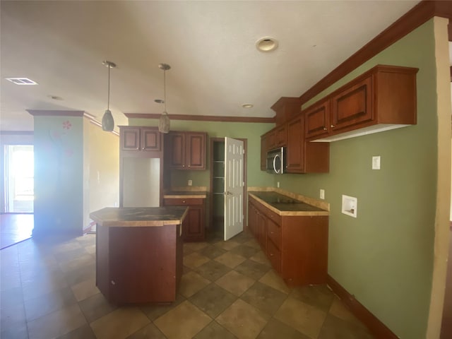 kitchen featuring hanging light fixtures and crown molding