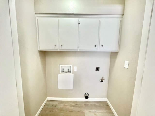 washroom with hookup for a washing machine, light hardwood / wood-style floors, hookup for an electric dryer, hookup for a gas dryer, and cabinets