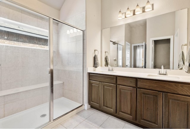 bathroom with lofted ceiling, tile patterned floors, a shower with shower door, and vanity