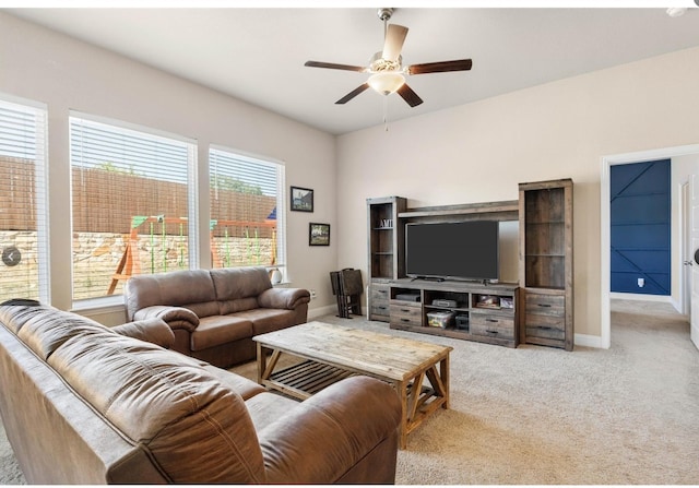 carpeted living room with ceiling fan