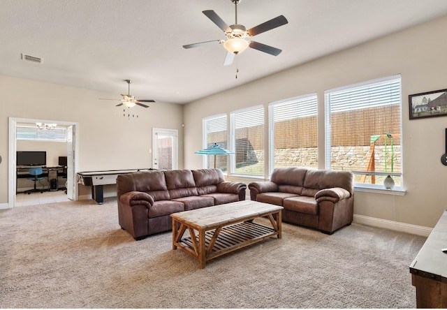 carpeted living room with ceiling fan and a wealth of natural light