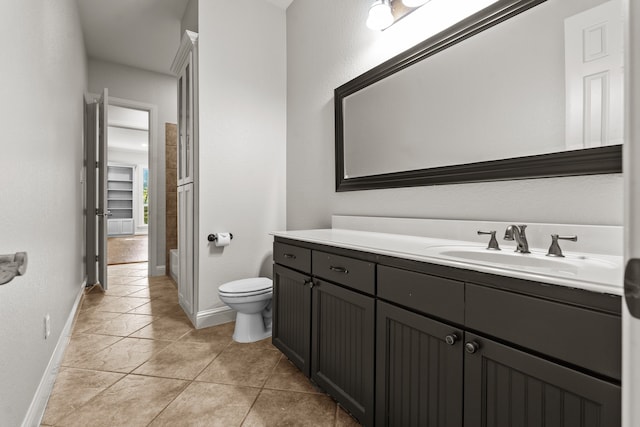 bathroom featuring tile patterned floors, vanity, and toilet