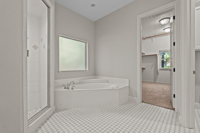 bathroom featuring shower with separate bathtub and a wealth of natural light