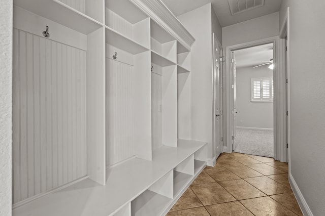 mudroom featuring ceiling fan and light tile patterned flooring