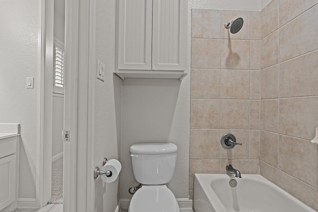 full bathroom with toilet, vanity, and tiled shower / bath