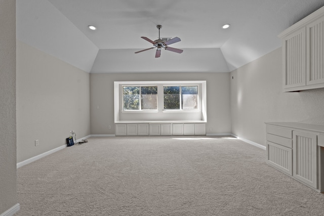 interior space with light colored carpet, vaulted ceiling, and ceiling fan