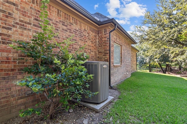 view of home's exterior featuring a yard and cooling unit