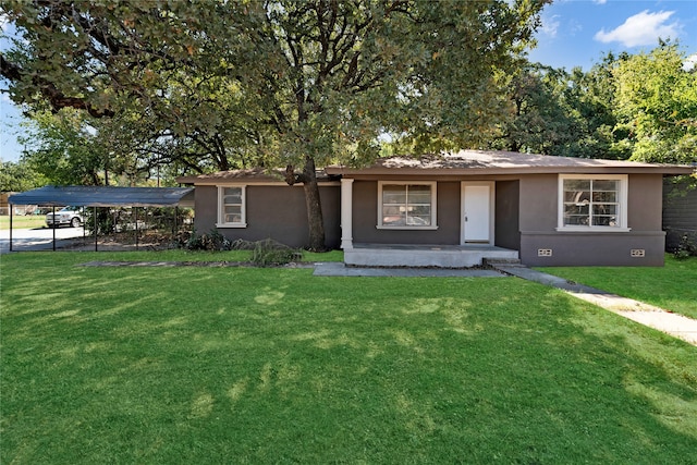 ranch-style home with a front lawn and a carport