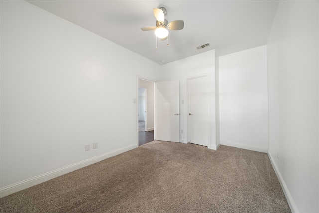 empty room featuring ceiling fan and carpet flooring