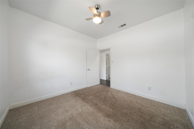 empty room with ceiling fan and carpet flooring