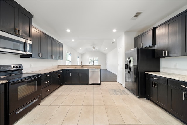 kitchen featuring lofted ceiling, black appliances, light stone counters, and light tile patterned floors