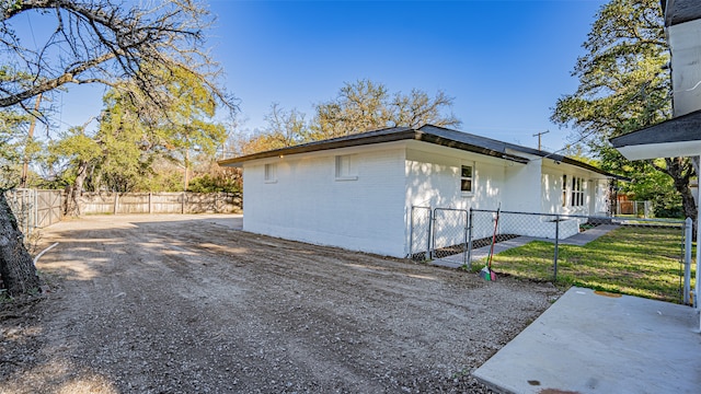 view of side of home with a yard