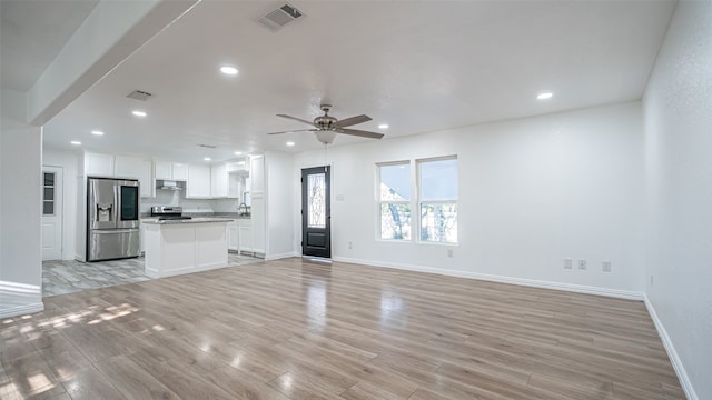 unfurnished living room featuring light hardwood / wood-style floors and ceiling fan