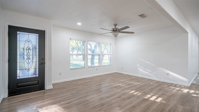 foyer entrance with ceiling fan and light hardwood / wood-style flooring