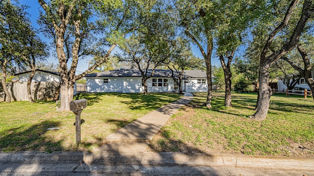 ranch-style home featuring a front yard