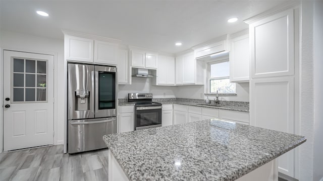 kitchen featuring exhaust hood, sink, stainless steel appliances, and white cabinets