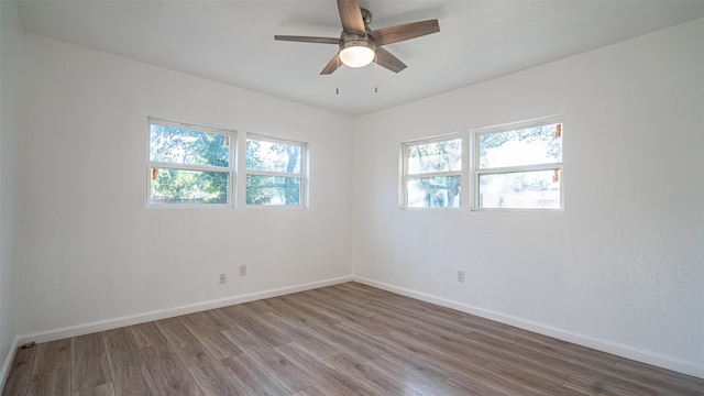 spare room featuring hardwood / wood-style floors and ceiling fan