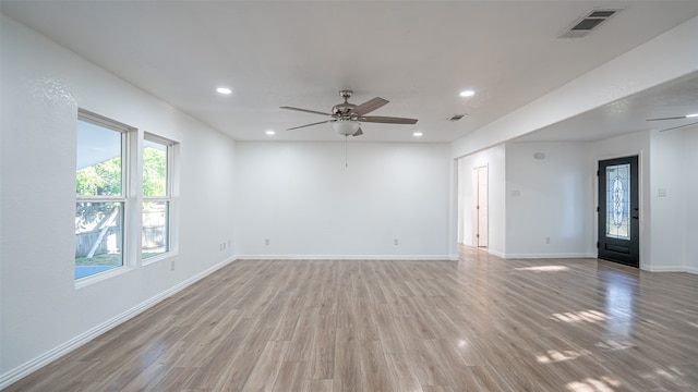 spare room featuring light wood-type flooring and ceiling fan