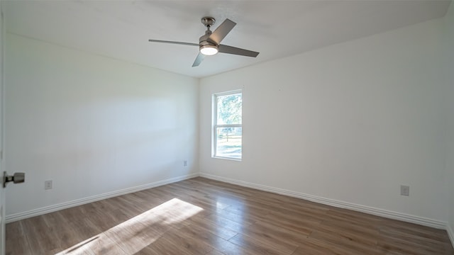 spare room featuring hardwood / wood-style floors and ceiling fan