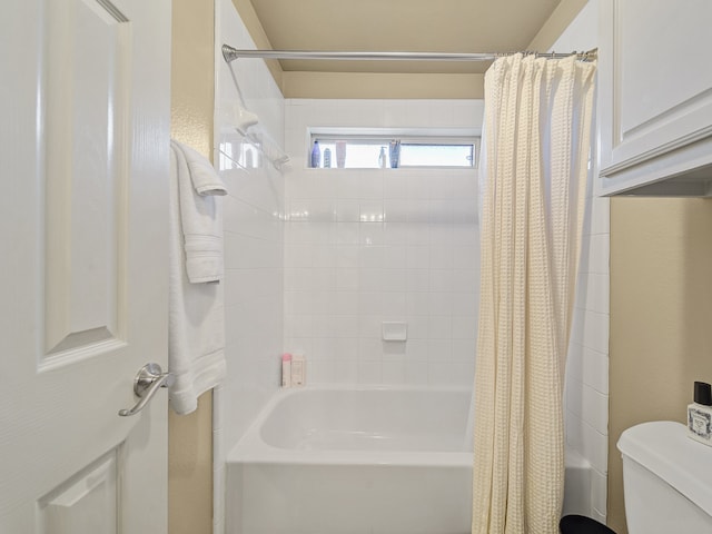 bathroom with shower / bath combination with curtain and toilet