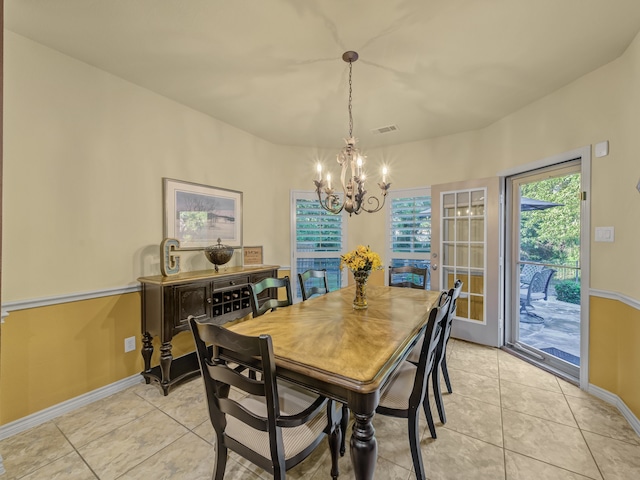 dining room featuring light tile patterned flooring and a chandelier