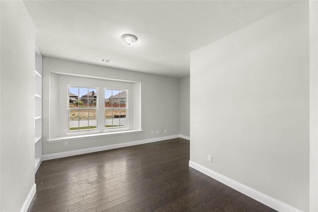 empty room with dark hardwood / wood-style floors