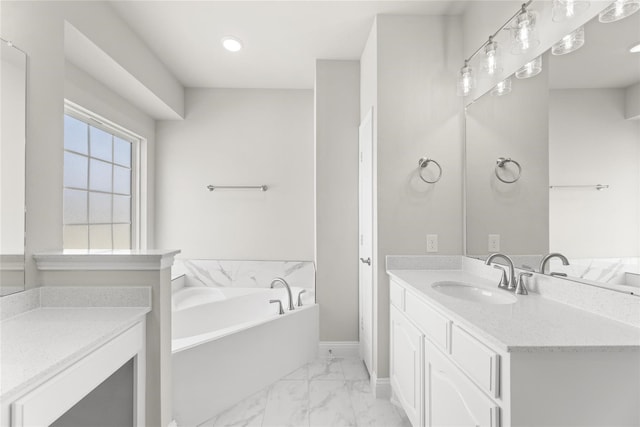 bathroom featuring vanity and a tub