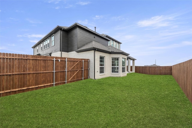 rear view of house featuring a yard