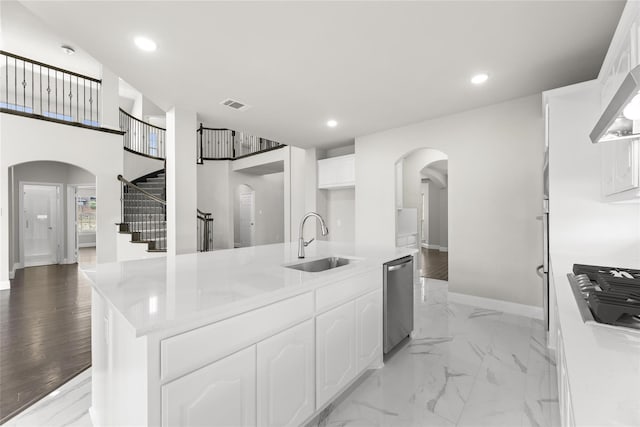 kitchen with light hardwood / wood-style floors, sink, white cabinets, gas cooktop, and stainless steel dishwasher