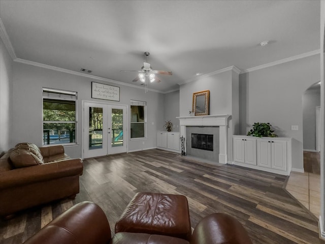 living room with ceiling fan, ornamental molding, and dark hardwood / wood-style flooring