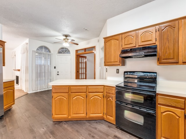 kitchen with ceiling fan, black electric range, hardwood / wood-style floors, and a textured ceiling