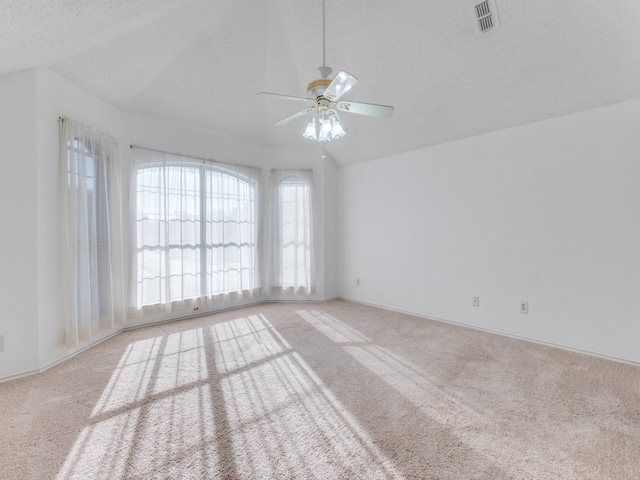 unfurnished room with ceiling fan, a textured ceiling, light carpet, and vaulted ceiling