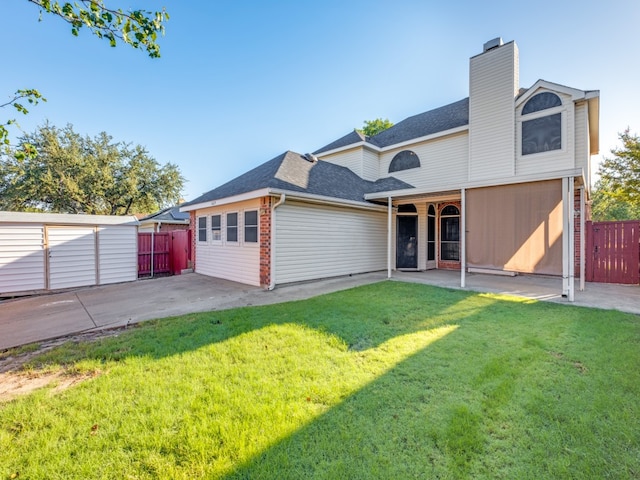 back of property featuring a yard and a patio area