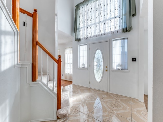 tiled foyer entrance featuring a high ceiling