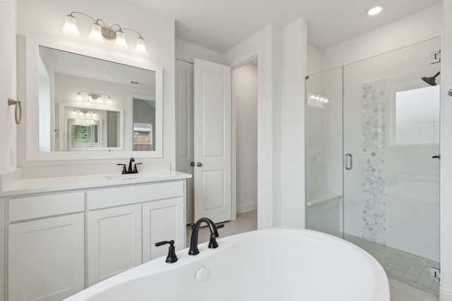 603 Mountain Laurel Rd, Wylie, TX 75098 - bathroom featuring vanity, a soaking tub, a shower stall, and recessed lighting