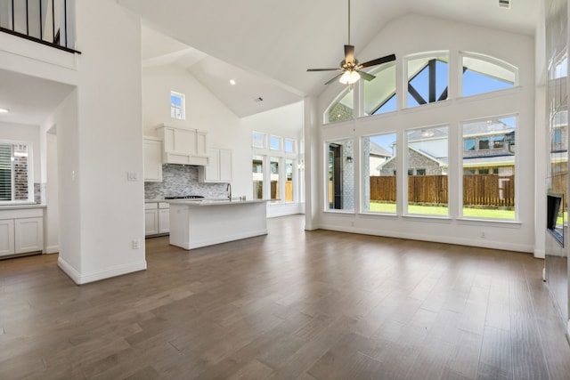 603 Mountain Laurel Rd, Wylie, TX 75098 - unfurnished living room with a healthy amount of sunlight, high vaulted ceiling, a ceiling fan, and dark wood finished floors