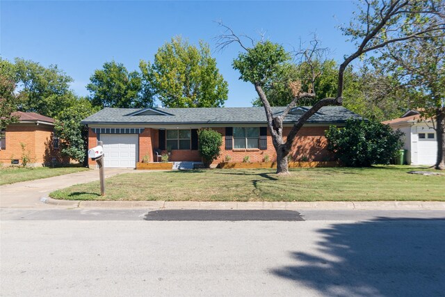 ranch-style house with a garage and a front lawn