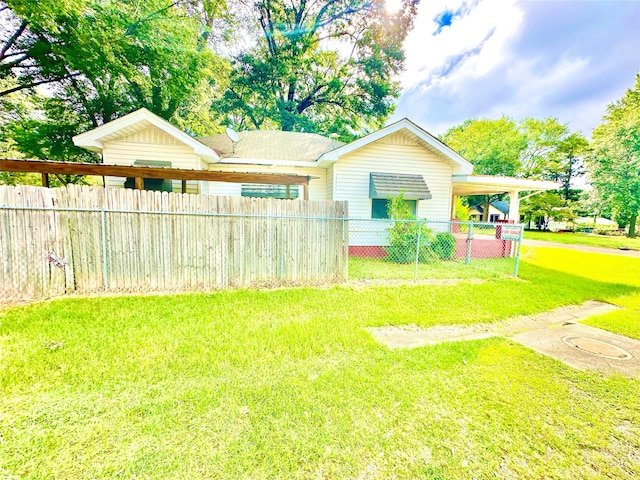 view of front of house with a front yard and a carport