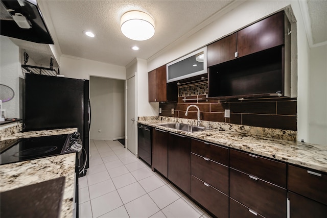 kitchen with light stone countertops, black appliances, decorative backsplash, sink, and light tile patterned floors